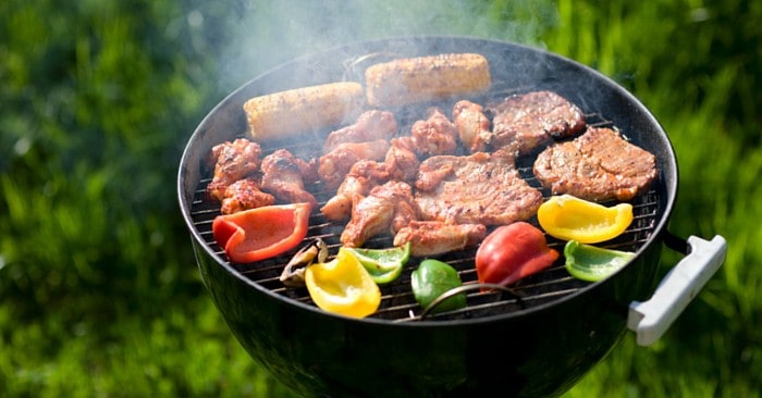 healthy foods cooking on a grill outdoors