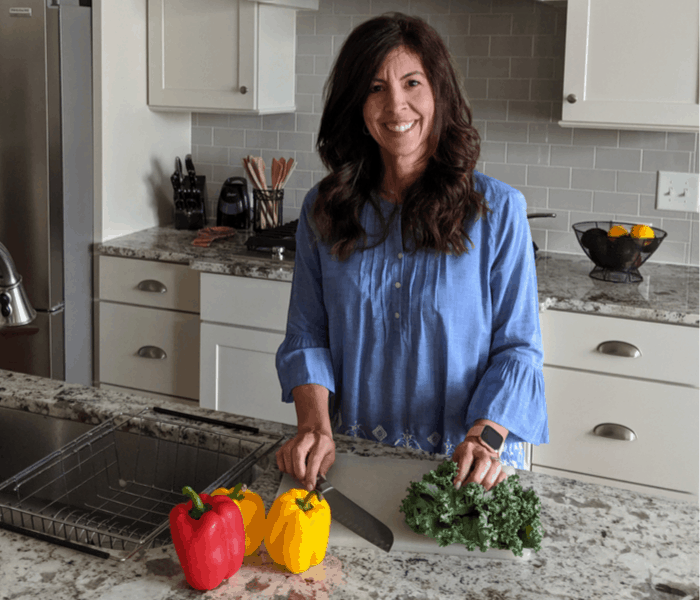 Stephanie cutting vegetables in kitchen