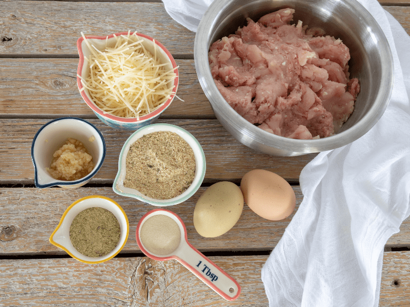 ingredients measured out in dishes beside ground turkey to make baked meatball recipe 