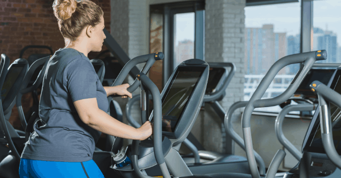 woman over 40 on gym equipment doing a fasted cardio workout