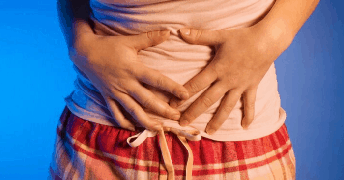 woman with hands on stomach