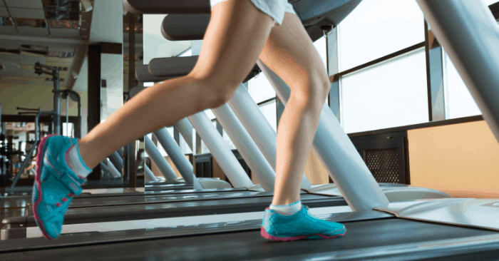 Legs of a woman on a treadmill.