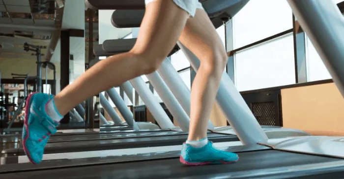 lady on treadmill doing a hiit workout to lose weight