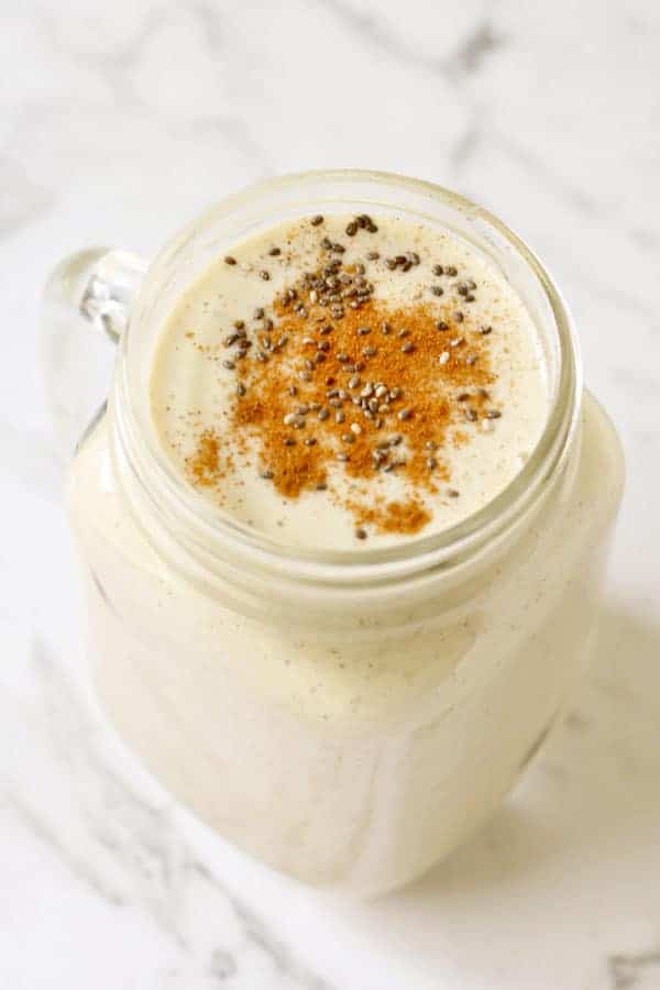 banana chia smoothie in a jar with garnishment on top