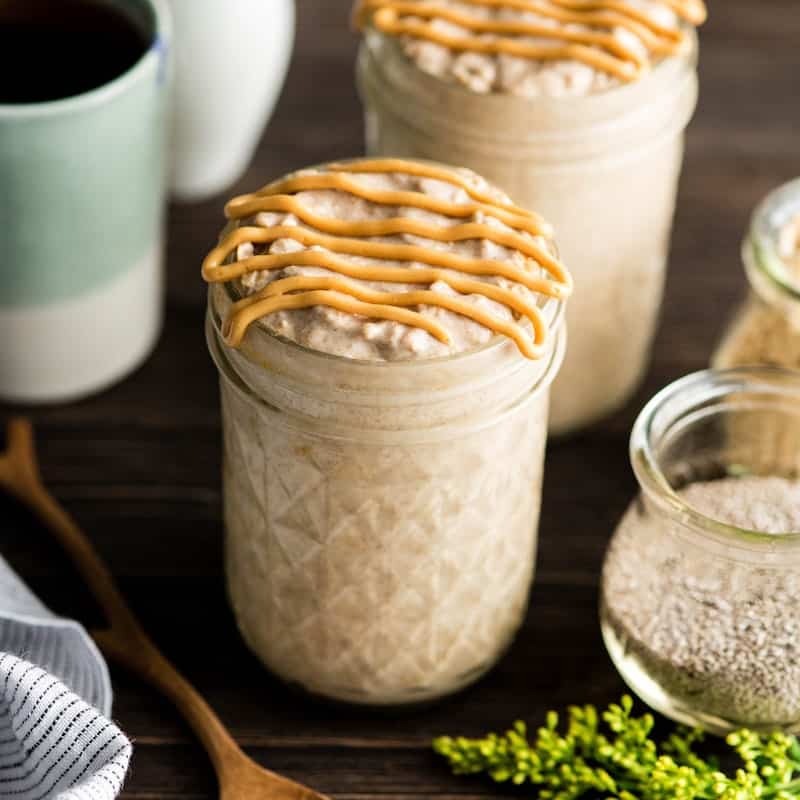 Peanut butter chia overnight oats in a glass jar with peanut butter drizzled on top