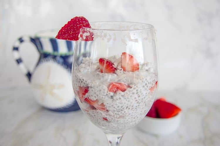 chia pudding with strawberries and coconut in a glass dish