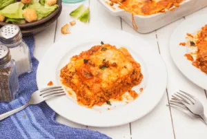 serving of low carb lasagna on a small plate with a fork