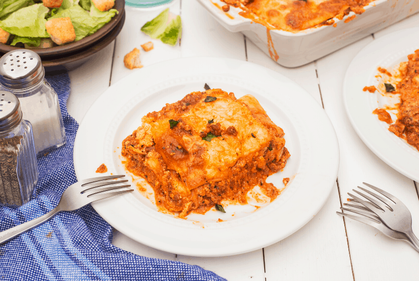 Serving of low carb lasagna on a small plate with a fork.