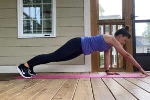 woman doing high plank reach