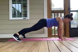 woman doing plank jacks