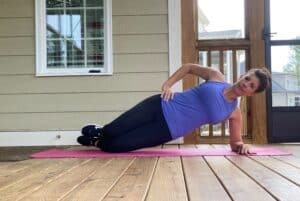 woman doing side plank on forearm