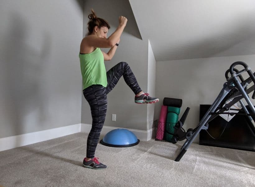 lady exercising standing with leg lifted