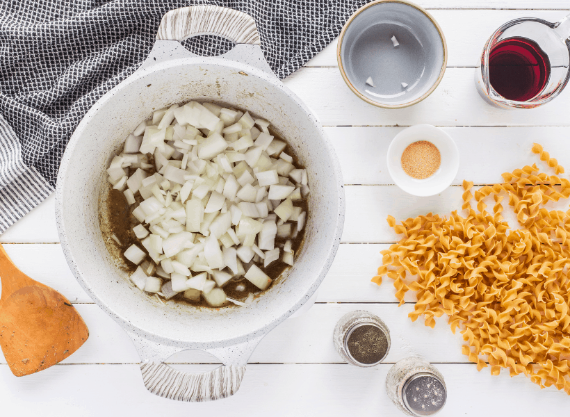 onions being browned in dutch oven