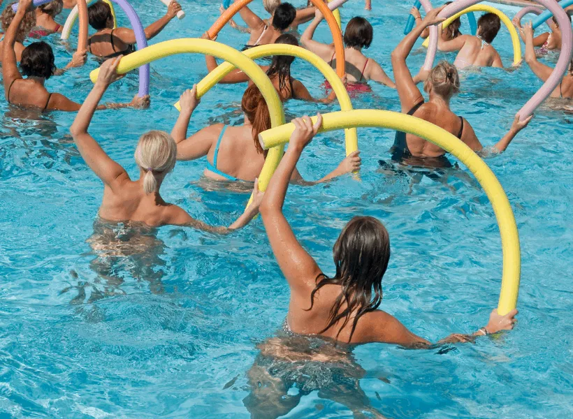 women doing water aerobics in swimming pool