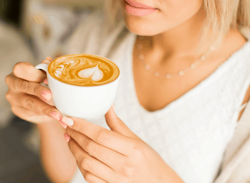 lady holding a cup of cacao butter coffee