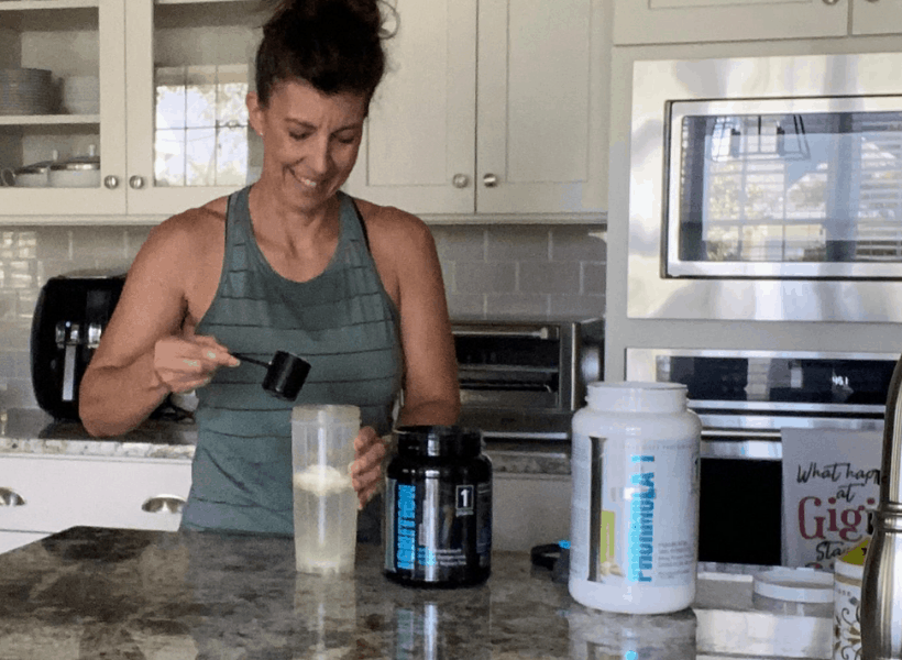 Stephanie mixing post workout shake in the kitchen.