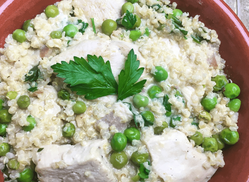 creamy quinoa with chicken and peas in a bowl