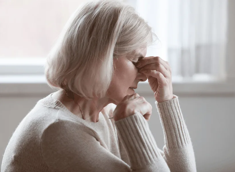 middle aged women holding her face perhaps in pain