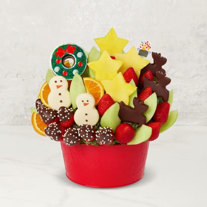 red container of fruit cut into shapes with holiday theme