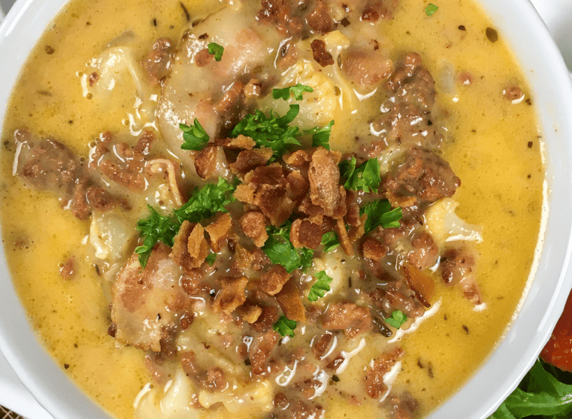 large bowl of bacon cheeseburger soup with bacon and fresh parsley as garnishment on top