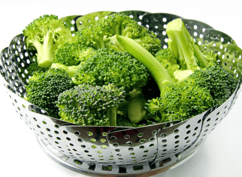 fresh broccoli in strainer ready to be roasted
