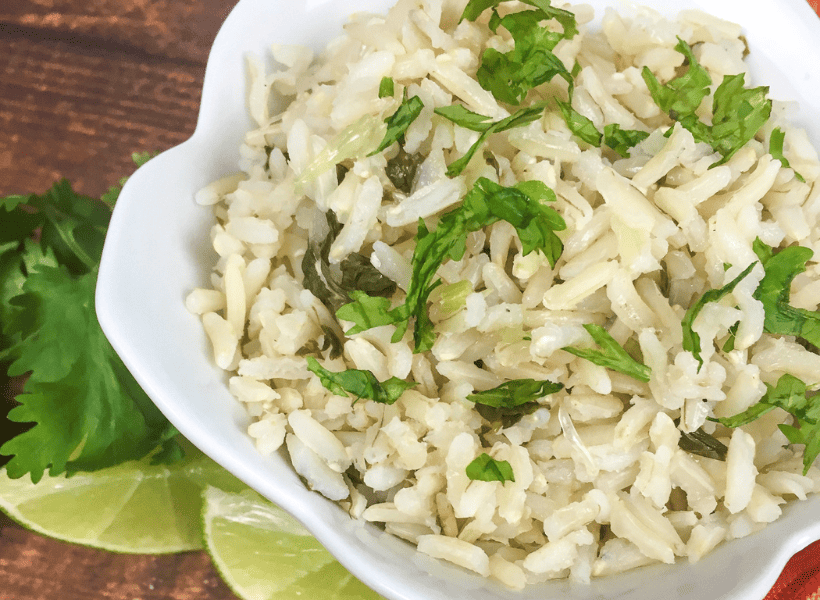 white bowl of cilantro rice with garnish on top