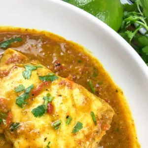 piece of fish in curry in a white bowl