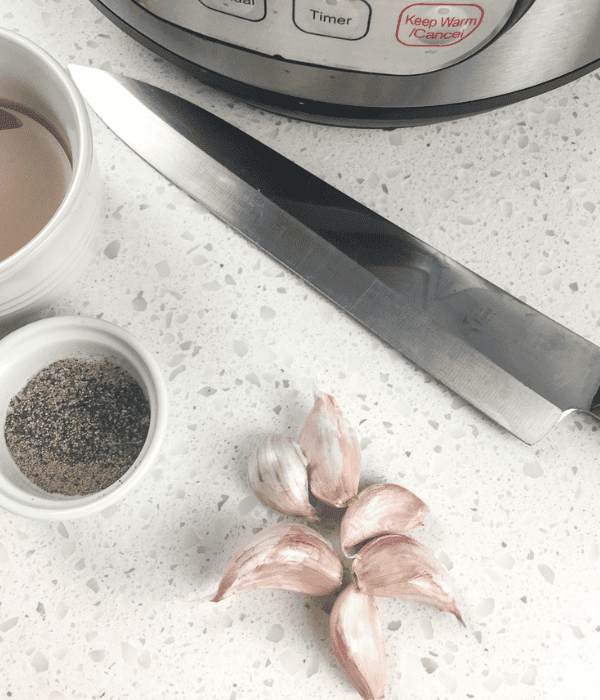 garlic, pepper and knife on counter