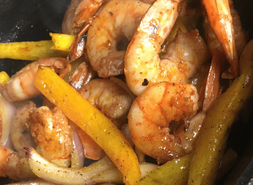shrimp and peppers mixed together after being cooked