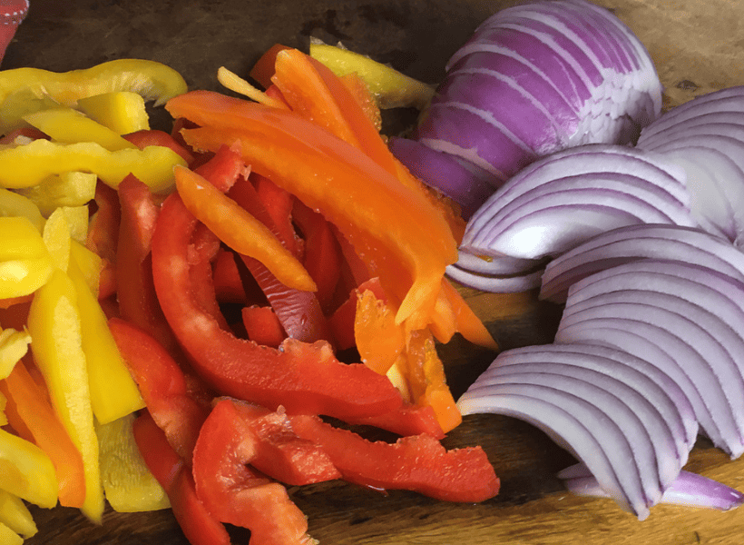 sliced yellow and red peppers and sliced red onions