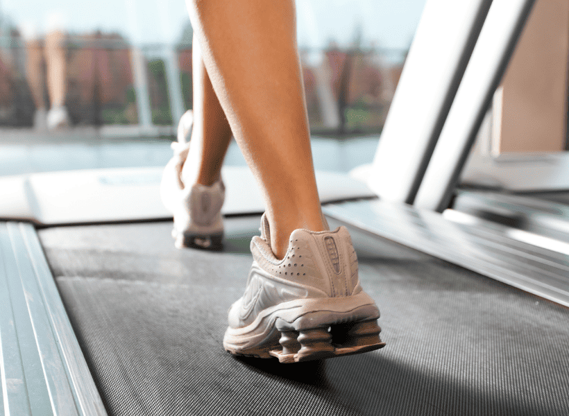 lady walking on treadmill - shown are her feet and legs below her knees