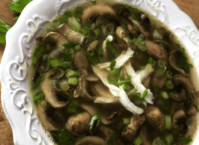 white bowl of chicken marsala soup with parsley garnishment