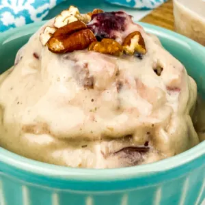 green bowl with frozen bananas ice cream with pecans on top