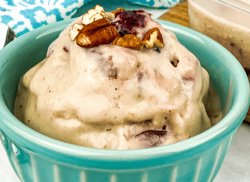 green bowl with frozen bananas ice cream with pecans on top