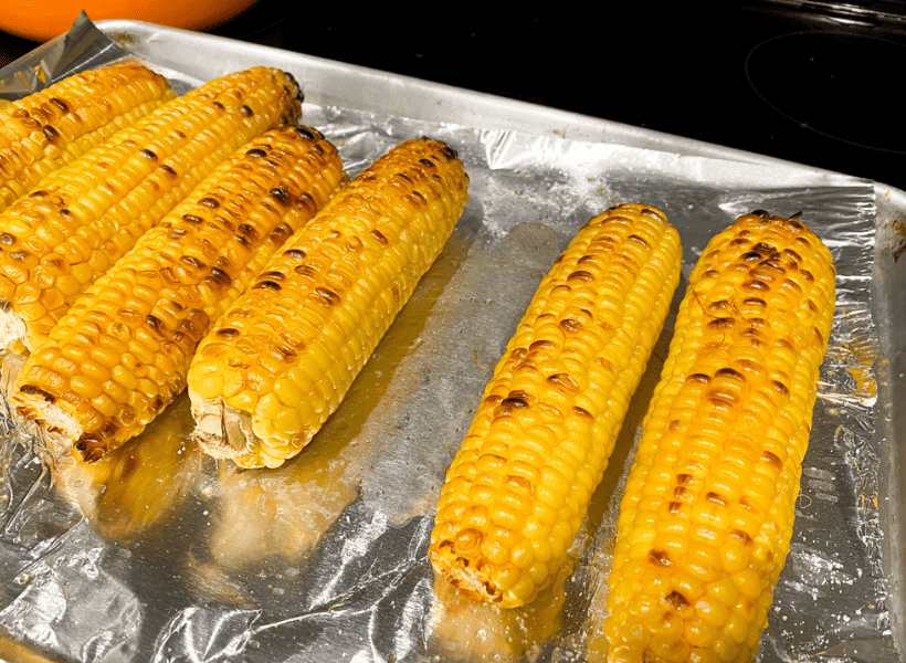 corn on cookie sheet after being cooked in oven