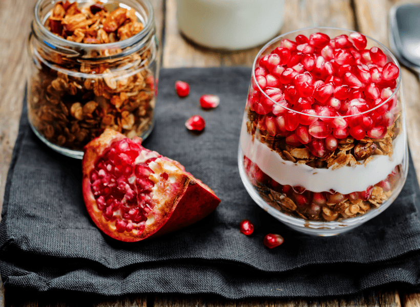 pomegranate in a parfait with yogurt and granola