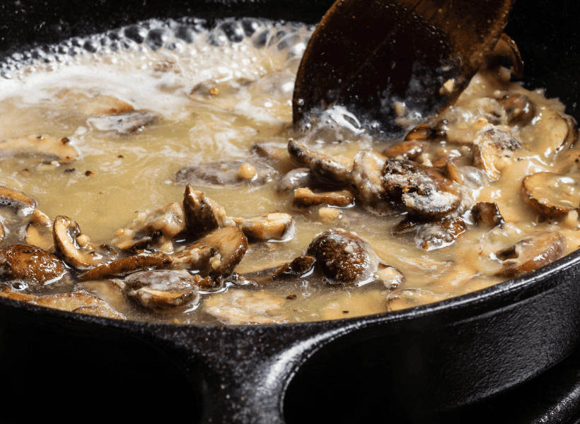 mushroom gravy simmering in cast iron skillet