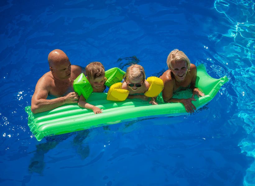 family of 4 on float in pool