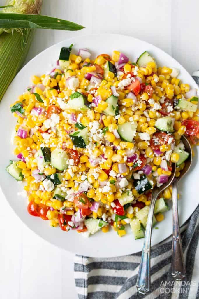 corn salad on a white plate with fork