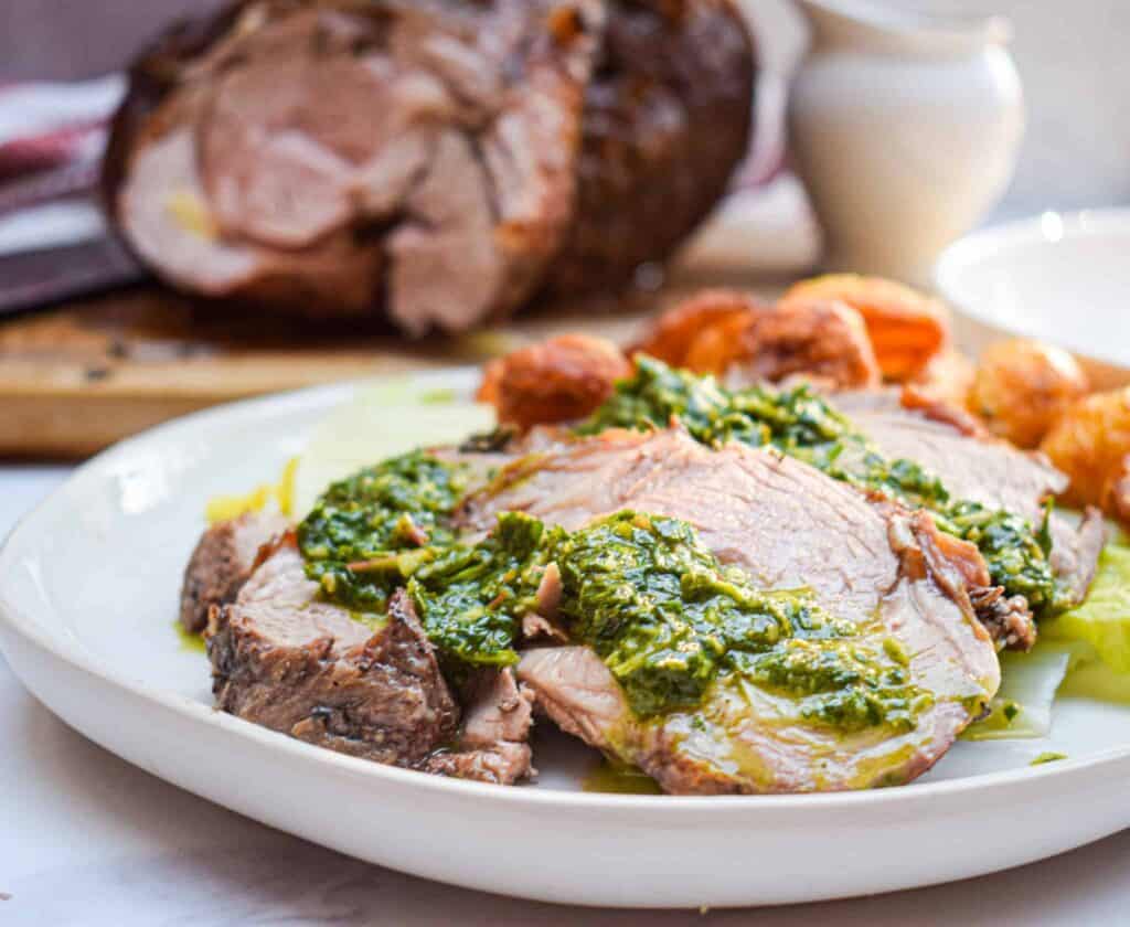 roast leg of lamb on a platter