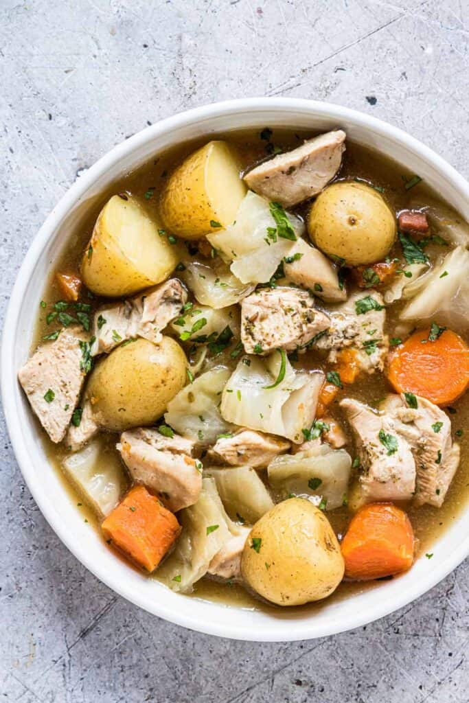 chicken stew from an instant pot in a white serving dish