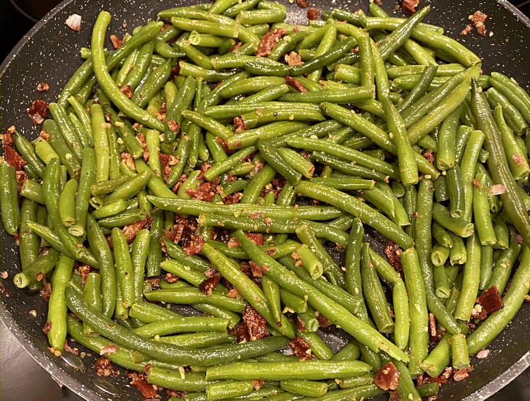 green beans with garlic and bacon in pan