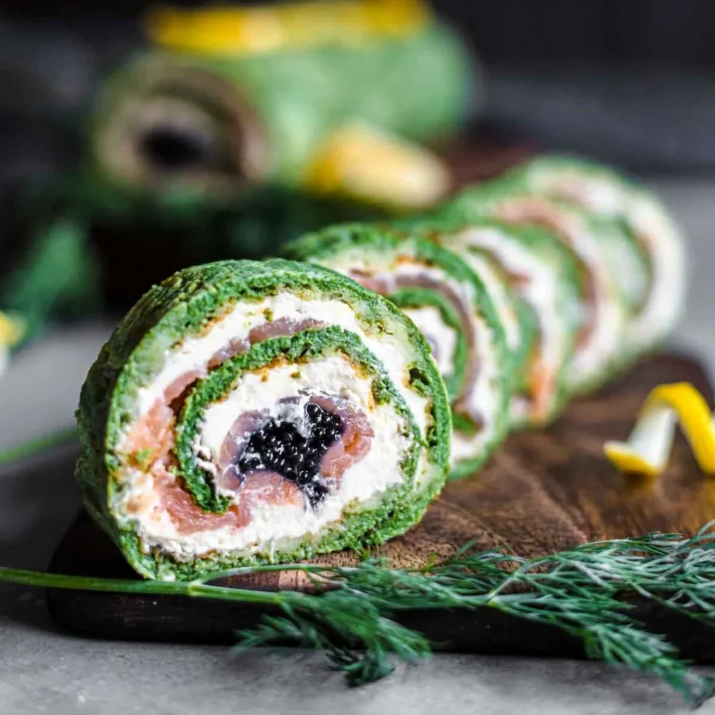 keto spinach salmon roulade with caviar on a cutting board