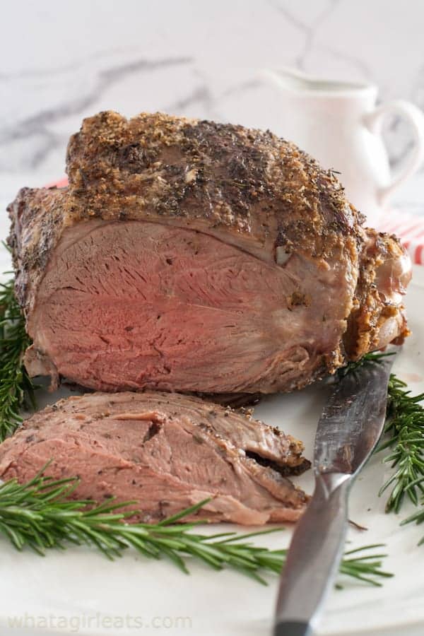 leg of lamb with rosemary and garlic on a platter