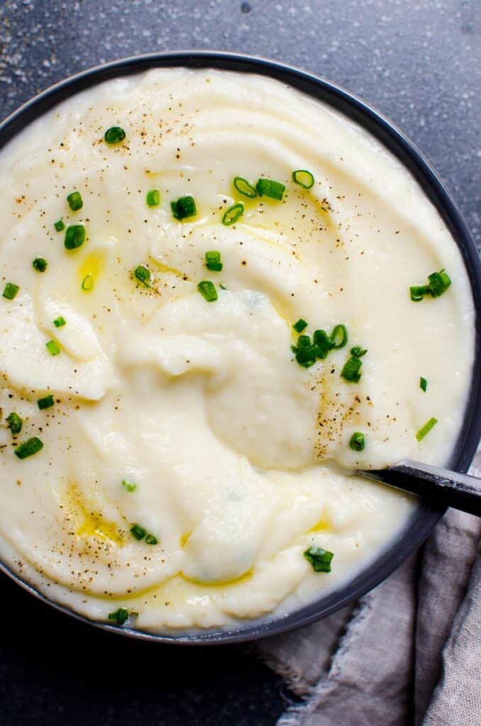 cauliflower mashed potatoes with garnishment in a bowl