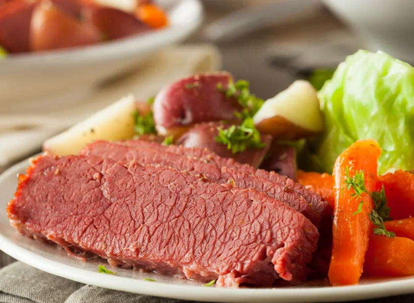 plate of irish dish corned beef with carrots and cabbage