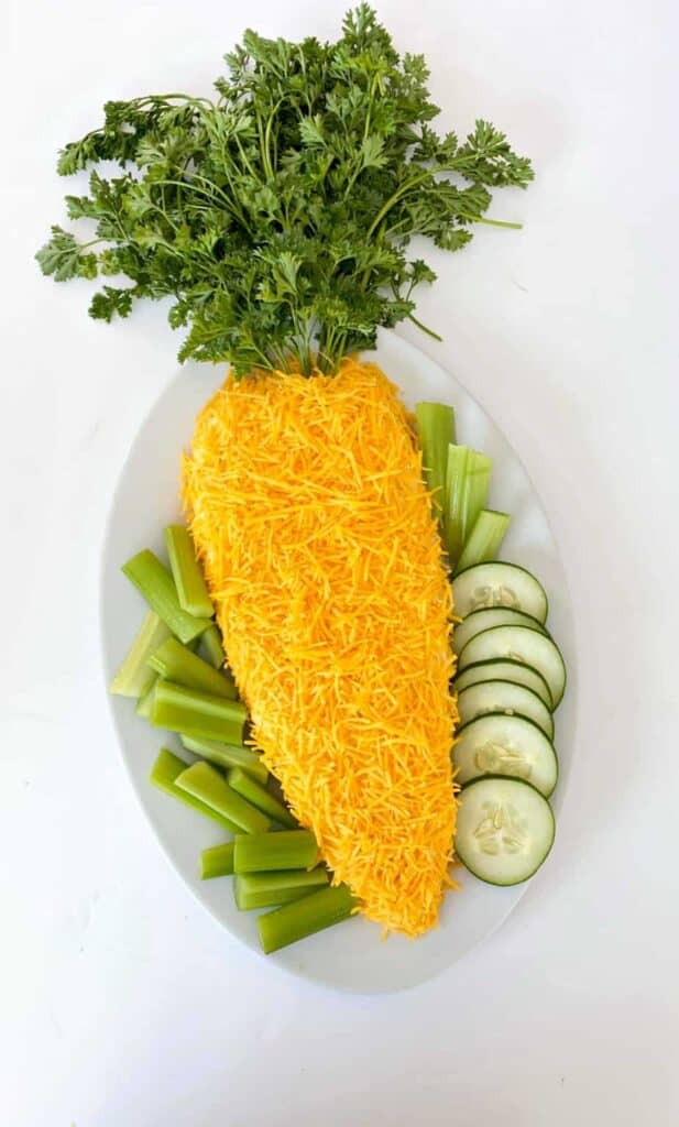 cheese ball in shape of carrot with cucumbers and celery