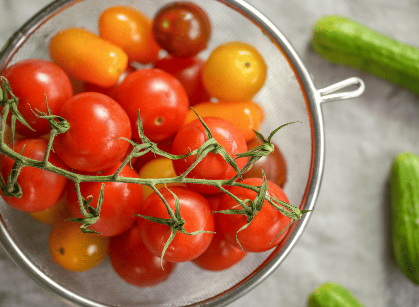bowl of fresh cherry tomatoes in strainer