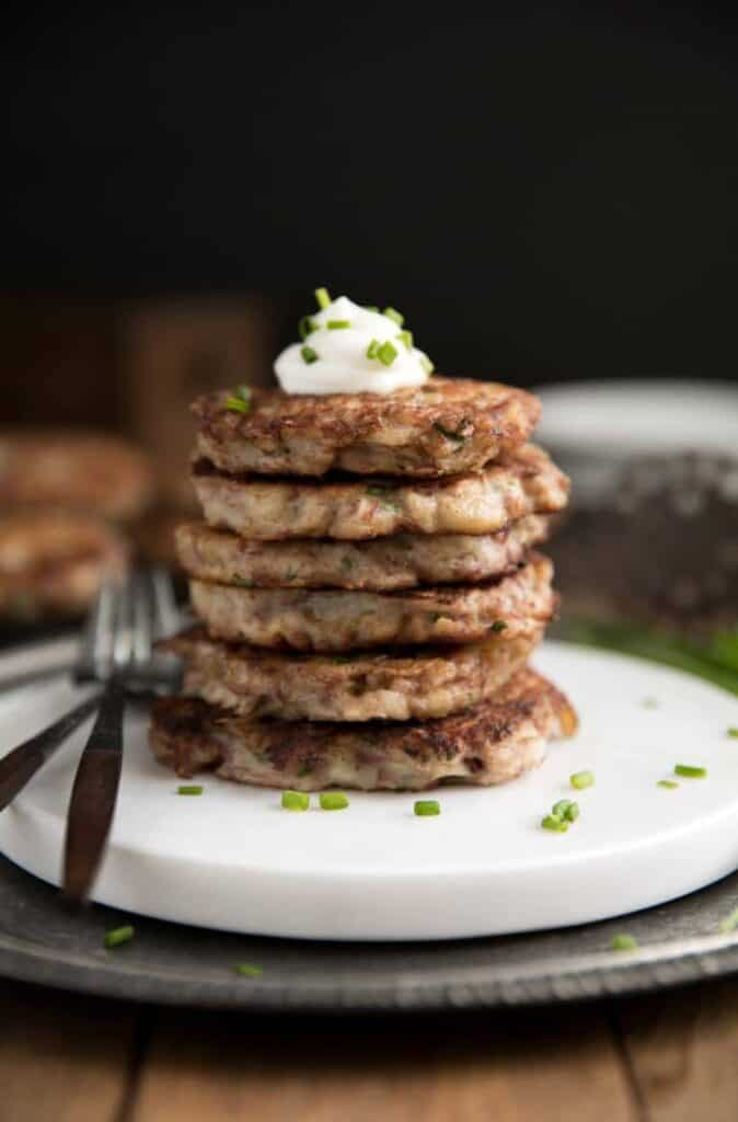 irish corned beef potato pancakes stacked on a white serving plate