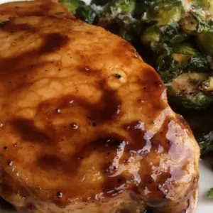 maple balsamic pork chops on plate with brussels sprouts